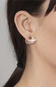 Gold earring with false clear quartz dilation