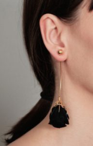 Long gold earring with a preserved natural black rose